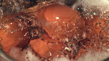 Super slow motion in boiling water with air bubbles boiled eggs. Macro background. Filmed on a high-speed camera at 1000 fps. video