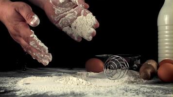 Super slow-moving men's hands cook baking at home. On a black background. Filmed on a high-speed camera at 1000 fps. video