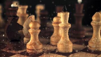 Super slow motion on the chessboard with the pieces falling drops of water. On a black background. Filmed on a high-speed camera at 1000 fps. video