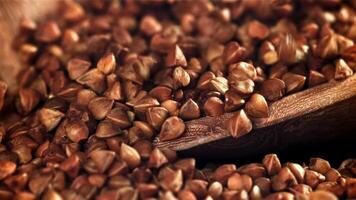 Buckwheat falling into a pile with a scoop. Filmed on a high-speed camera at 1000 fps. High quality FullHD footage video