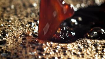 A stream of black coffee with splashes. Filmed on a high-speed camera at 1000 fps. High quality FullHD footage video