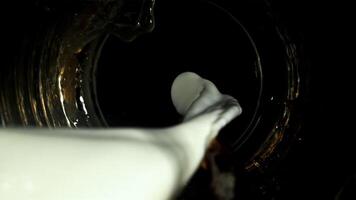 Mixing milk and coffee streams. Top view. Filmed on a high-speed camera at 1000 fps. High quality FullHD footage video