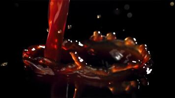 A stream of black coffee with splashes. Filmed on a high-speed camera at 1000 fps. High quality FullHD footage video