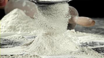 The cook sifts the flour. Filmed on a high-speed camera at 1000 fps. High quality FullHD footage video