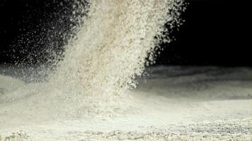 The flour is sifted through a sieve. On a black background. Filmed on a high-speed camera at 1000 fps. High quality FullHD footage video