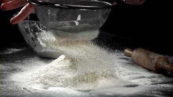 The cook sifts the flour. Filmed on a high-speed camera at 1000 fps. High quality FullHD footage video