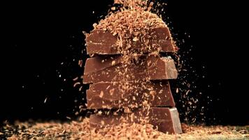 The grated chocolate falls on the chocolate slices. Filmed on a high-speed camera at 1000 fps. High quality FullHD footage video