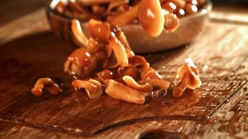 Pickled mushrooms fall on a wooden board. Filmed on a high-speed camera at 1000 fps. High quality FullHD footage video