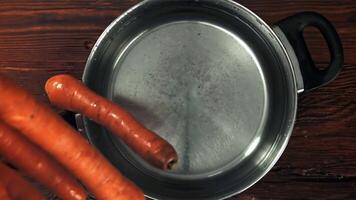 Carrot falls into a pot of water. Filmed is slow motion 1000 fps. High quality FullHD footage video