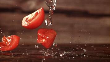 Tomato slices fall on the table. Filmed is slow motion 1000 fps. High quality FullHD footage video