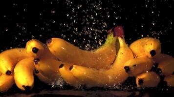 Super slow motion water droplets fall on bananas. On a black background. Filmed on a high-speed camera at 1000 fps. video