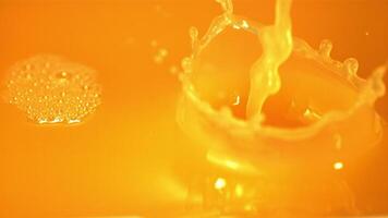 Super slow motion orange juice pours with a stream. Filmed at 1000 fps.Macro background. video