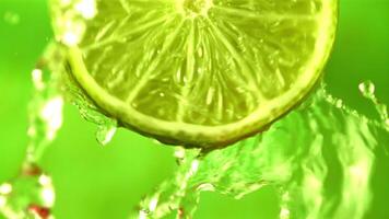 Super slow motion with a piece of juicy lime draining water. On a green background. Filmed on a high-speed camera at 1000 fps. video