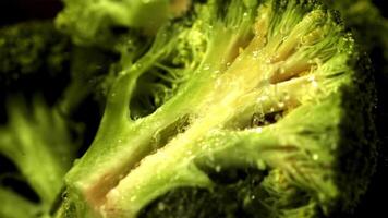 Super slow motion on a piece of broccoli drops water. Macro background.Filmed on a high-speed camera at 1000 fps. High quality FullHD footage video