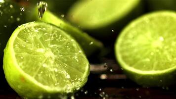 Super slow motion on half the juicy lime dripping water. Against a dark background.Filmed at 1000 fps. video