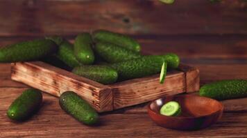 Super slow motion round pieces of cucumber fall into a wooden plate. On a wooden background. Filmed on a high-speed camera at 1000 fps. High quality FullHD footage video