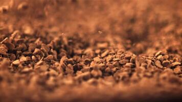 Super slow motion pellets of instant coffee fall into a heap. Macro background. Filmed on a high-speed camera at 1000 fps.High quality FullHD footage video