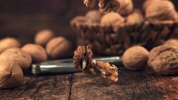 Super slow motion peeled walnut falls on the table. On a wooden background.Filmed on a high-speed camera at 1000 fps. video