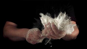 Super slow motion men's hands with rolling pin with flour sprays. On a black background. Filmed on a high-speed camera at 1000 fps. video