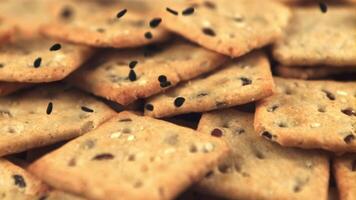 Super slow motion on the cracker falling sesame seeds. Macro background.Filmed on a high-speed camera at 1000 fps. High quality FullHD footage video