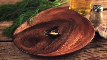 Super slow motion boiled mussels fall into a wooden plate. On a wooden background. Filmed on a high-speed camera at 1000 fps. video