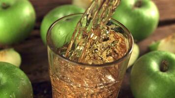 Super slow motion juice from green apples pours into a glass of air bubbles. On a wooden background. Filmed on a high-speed camera at 1000 fps. video