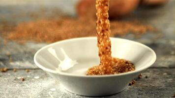 Super slow motion fresh mustard falls into a plate on the table. On a gray background. Filmed on a high-speed camera at 1000 fps. High quality FullHD footage video