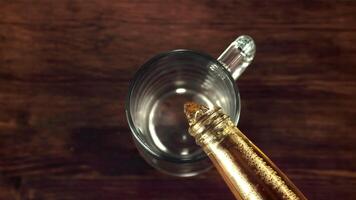 Super slow motion in the glass pours fragrant beer. On a wooden background.Filmed on a high-speed camera at 1000 fps. video