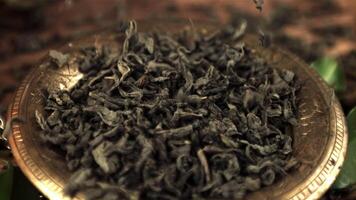 Super slow motion on the plate fall dry leaves of fragrant tea. Macro background.Filmed on a high-speed camera at 1000 fps. video