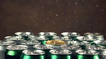 Super slow motion water droplets fall on tins with beer. On a gray background.Filmed on a high-speed camera at 1000 fps. High quality FullHD footage video