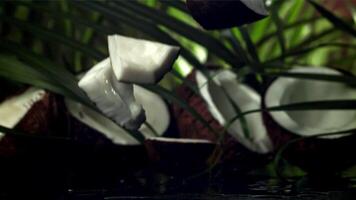 Pieces of coconut fall on the table. Filmed on a high-speed camera at 1000 fps. High quality FullHD footage video