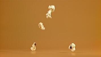 Popcorn falls on the table. Filmed on a high-speed camera at 1000 fps. High quality FullHD footage video