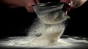 The cook sifts the flour. Filmed on a high-speed camera at 1000 fps. High quality FullHD footage video