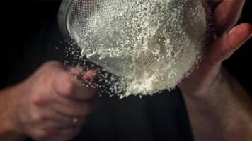 The cook sifts the flour. Filmed on a high-speed camera at 1000 fps. High quality FullHD footage video