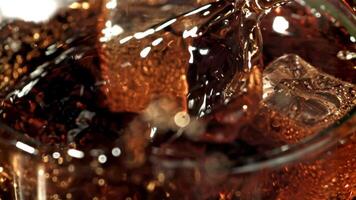 Ice cubes fall into a glass with cola. Filmed is slow motion 1000 fps. High quality FullHD footage video