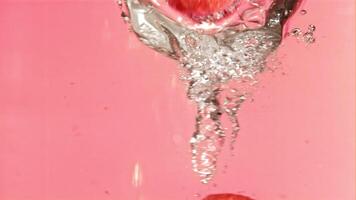 Fresh raspberries fall into the whirlpool. Filmed is slow motion 1000 fps. High quality FullHD footage video