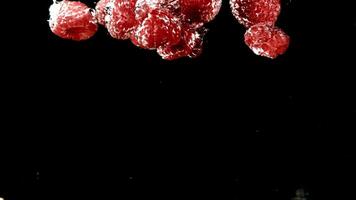 Raspberries fall under water. Filmed is slow motion 1000 fps. High quality FullHD footage video
