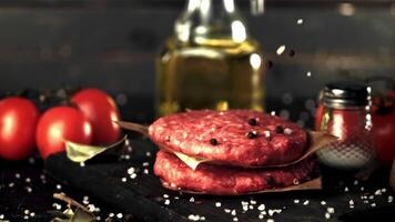 Super slow motion spices fall on the raw burger. On a black background. Filmed on a high-speed camera at 1000 fps. video