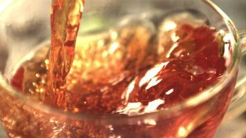 Super slow motion tea pours into the cup whirlpool. Macro background.Filmed on a high-speed camera at 1000 fps. video