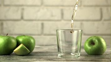 Super slow motion in the glass pours juice from fresh green apples. On a white background.Filmed on a high-speed camera at 1000 fps. video