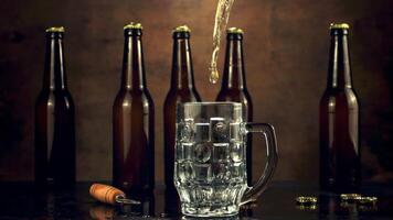 Super slow motion in the glass pours beer jet and spray. On a brown background.Filmed on a high-speed camera at 1000 fps. video