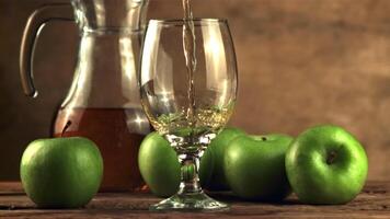 Super slow motion in the glass pours apple juice whirlpool. On a brown background. Filmed on a high-speed camera at 1000 fps. video