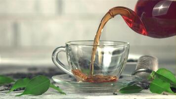 Super slow motion from the teapot is poured into a cup of black tea. On a white background. Filmed on a high-speed camera at 1000 fps. video