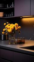 A Black Kitchen and Table Top With a Vase of Flowers. . photo