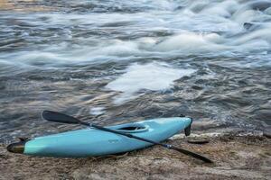 kayak on river shore photo