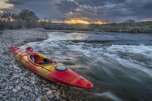 whitewater kayak at sunset photo