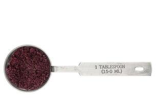 acai berry powder in a measuring tablespoon photo