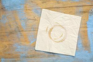 napkin with coffee stains on wood photo