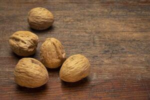 English walnuts on rustic wood photo