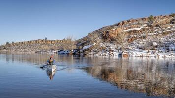 senior male is paddling expedition canoe photo